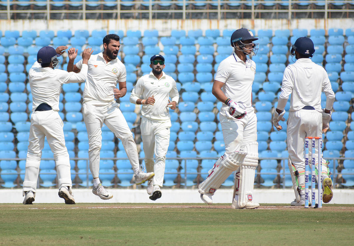 JOB WELL DONE: Vidarbha's left-arm spinner Aditya Sarwate (second from left) bowled brilliantly to bag the all-important wicket of Cheteshwar Pujara on Monday.  