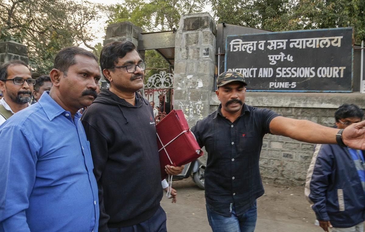 Activist Anand Teltumbde (wearing black pullover) leaves after Pune District and Sessions Court released him in Bhima Koregaon case, in Pune, February 2, 2019. (PTI Photo)