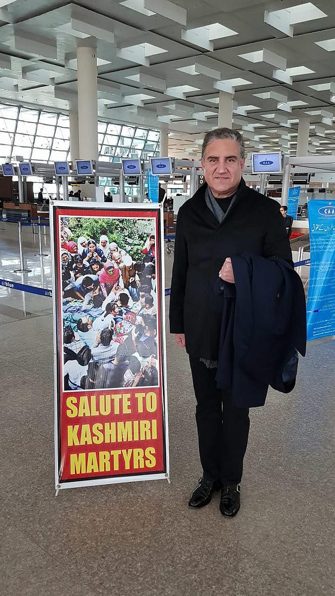 Pakistan Foreign Minister Shah Mehmood Qureshi poses for a photograph before leaving for London, at Islamabad airport, in Pakistan