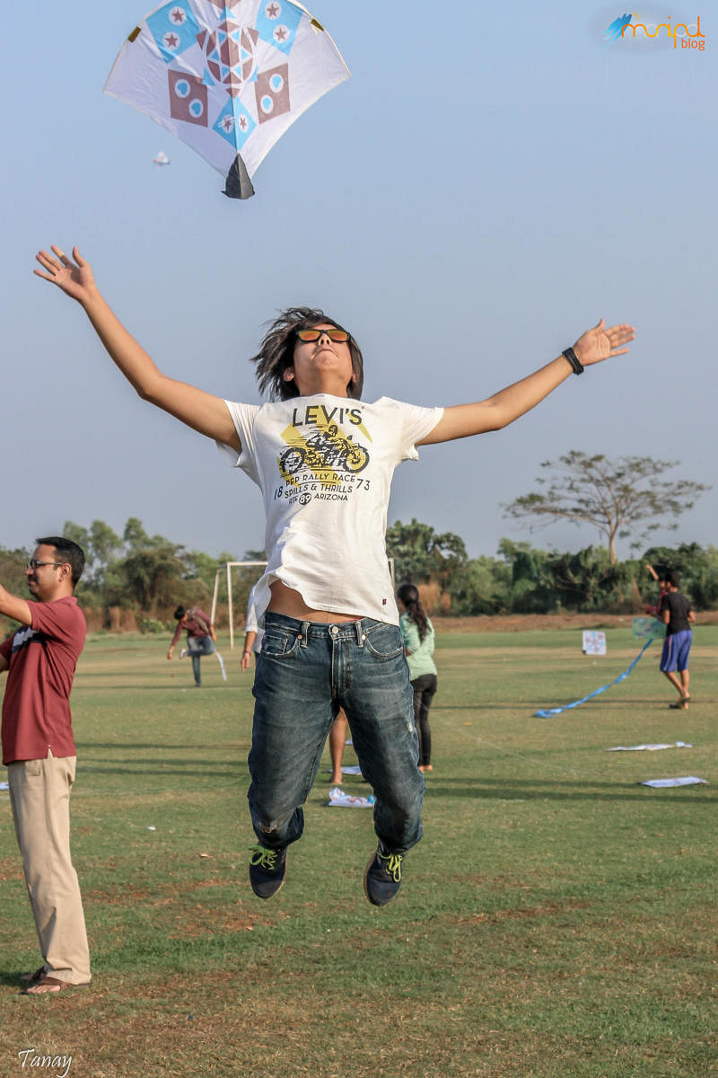 A student releases a kite 'Tarang', annual Kite Festival held at End Point in Manipal.