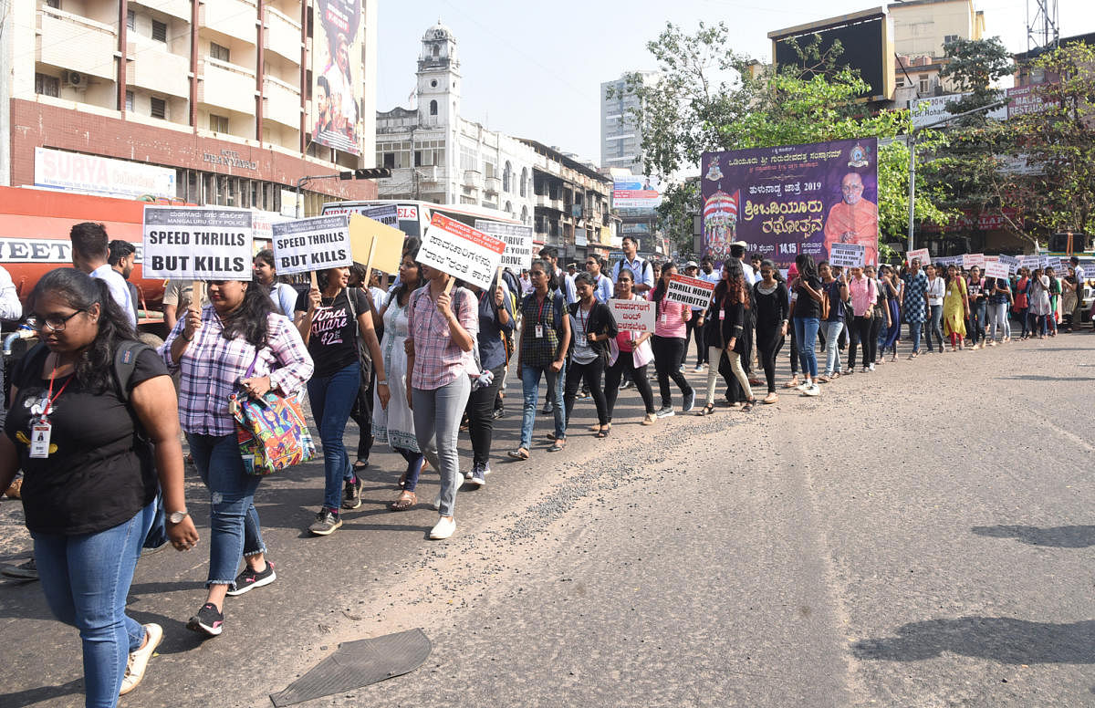 Students take out a rally to create awareness on road safety in Mangaluru on Monday. 