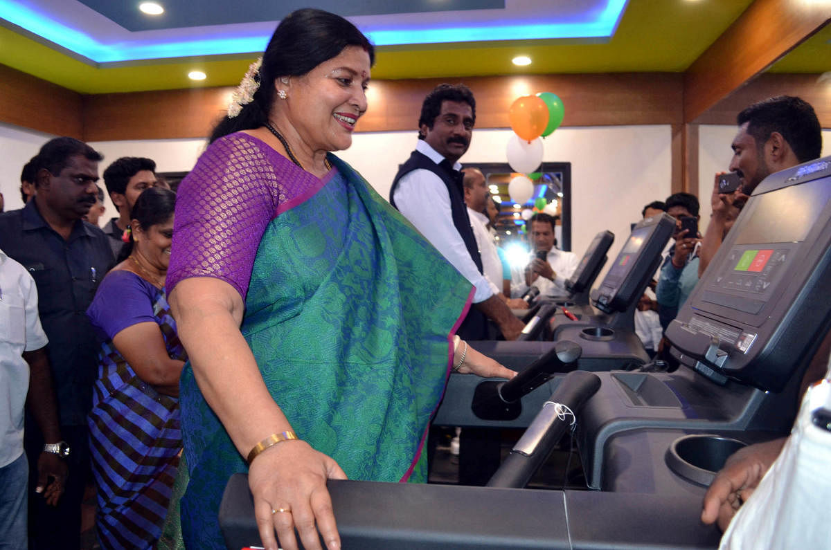 District In-charge Minister Jayamala and Minister for Youth Empowerment and Sports Rahim Khan walk on treadmill after the inauguration of synthetic tennis court in Udupi on Monday.(Right) Jayamala plays tennis on the occasion.