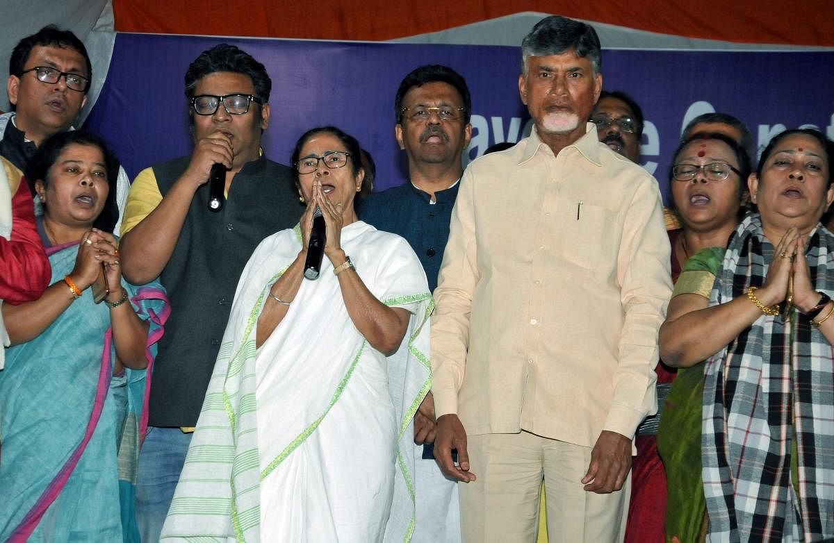 West Bengal Chief Minister Mamata Banerjee with TDP chief and Andhra Pradesh Chief Minister N Chandrababu Naidu stand for national anthem after announcing the end of her 46-hour-long 'Save Constitution' dharna in Kolkata, Tuesday, Feb 5, 2019. PTI