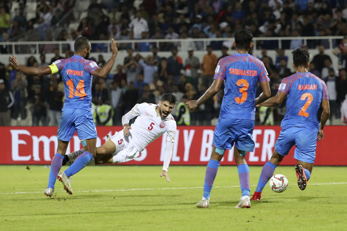 India's midfielder Pronay Halder (1st-L) fouls Bahrain's defender Hamad Alshamsan (2nd-L) during the 2019 AFC Asian Cup group A football match between India and Bahrain at the Sharjah Stadium in Sharjah on January 14, 2019. (AFP Photo)