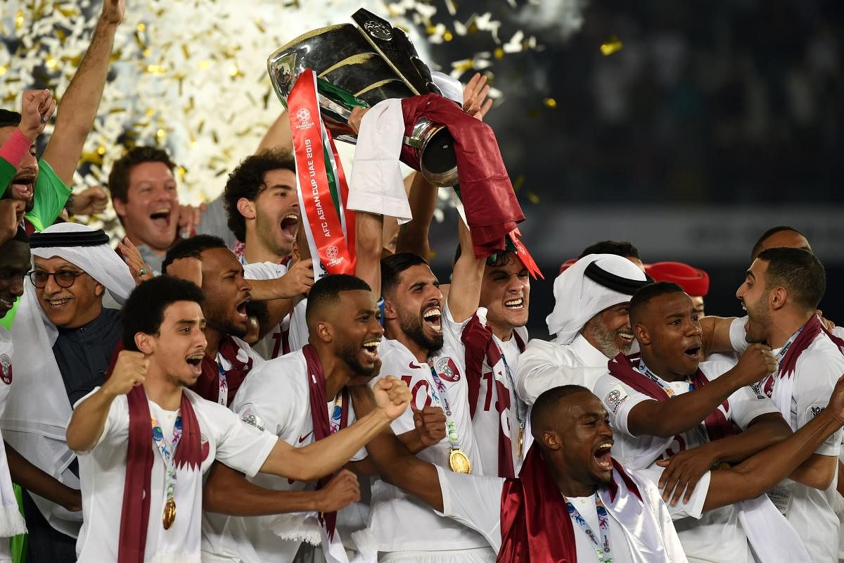 Qatar's players celebrate with the trophy after winning the 2019 AFC Asian Cup final football match between Japan and Qatar at the Zayed Sports City Stadium in Abu Dhabi on February 1, 2019. (AFP File Photo)