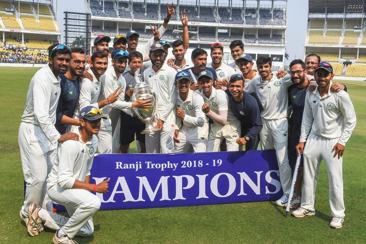 Vidarbha players celebrate with the Ranji Trophy after defeating Saurashtra in the final in Nagpur on Thursday. PTI