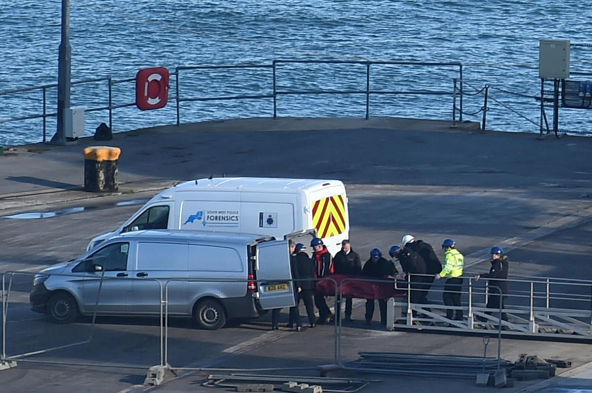 A body is taken off the Geo Ocean III, recovered from the wreckage of a plane carrying Argentine footballer Emiliano Sala at Weymouth harbour, south-west England.(AFP Photo/Glyn Kirk)