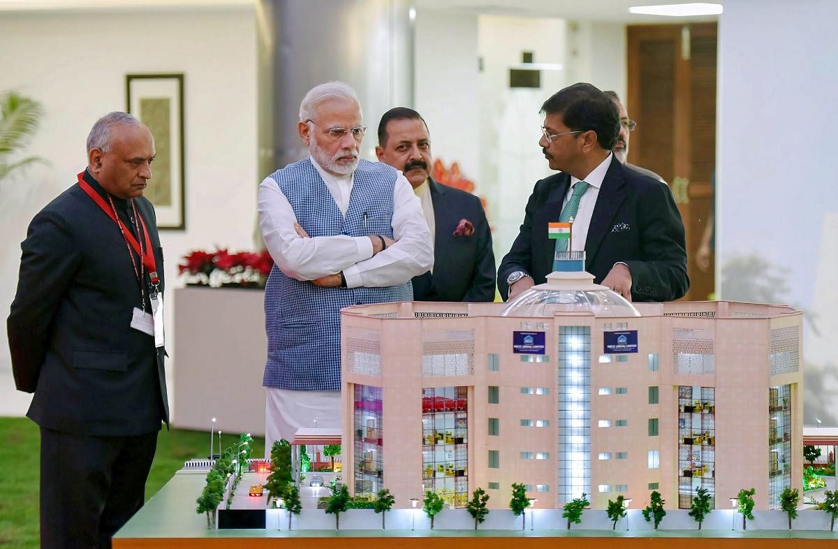 Prime Minister Narendra Modi views a model of the newly inaugurated premises of the Central Information Commission, in New Delhi. PTI File  Photo