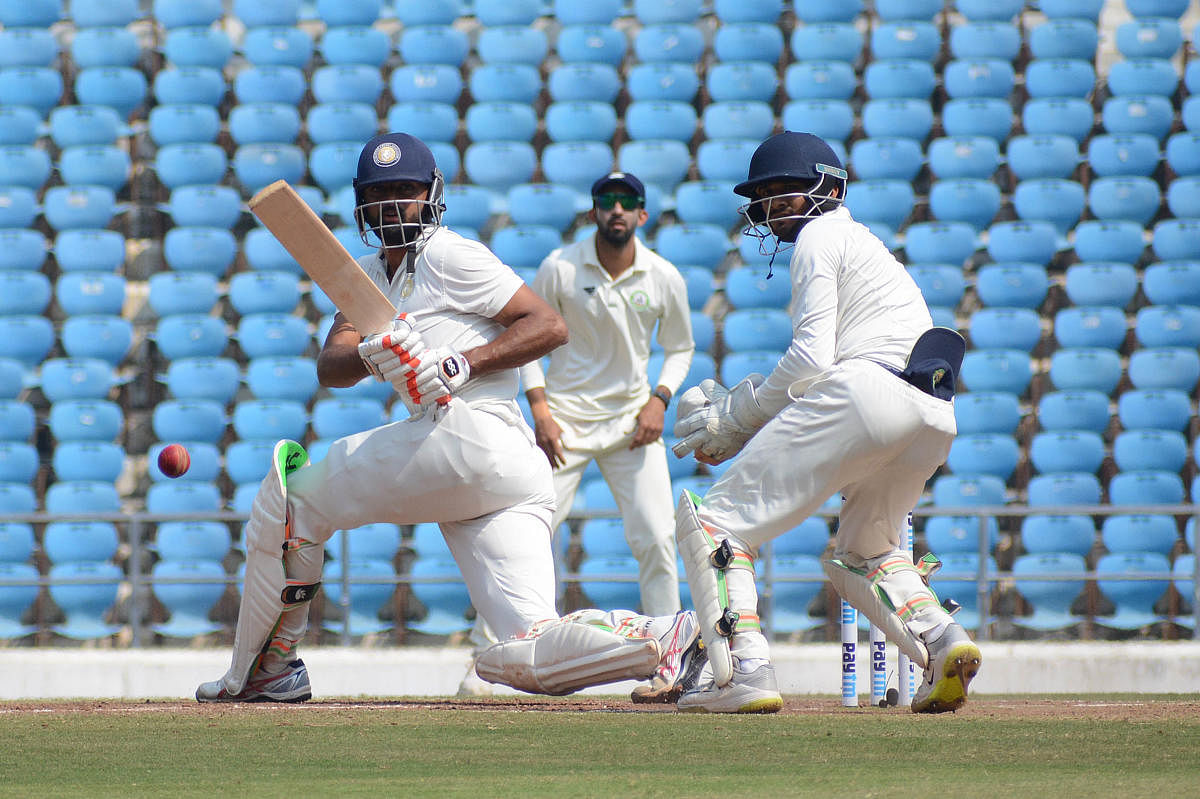 Saurashtra's Jaydev Unadkat sweeps one to the boundary his fighting knock of 46 against Vidarbha on Tuesday. 