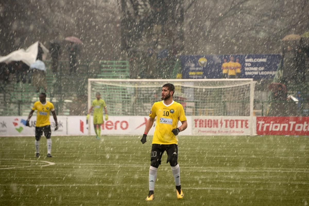 In this photo taken on February 6, 2019, Real Kashmir's Danish Farooq looks on amid snowfall during their I-League club football match against Gokulam Kerala FC at the Tourist Reception Centre football ground in Srinagar. - Real Kashmir is the first club