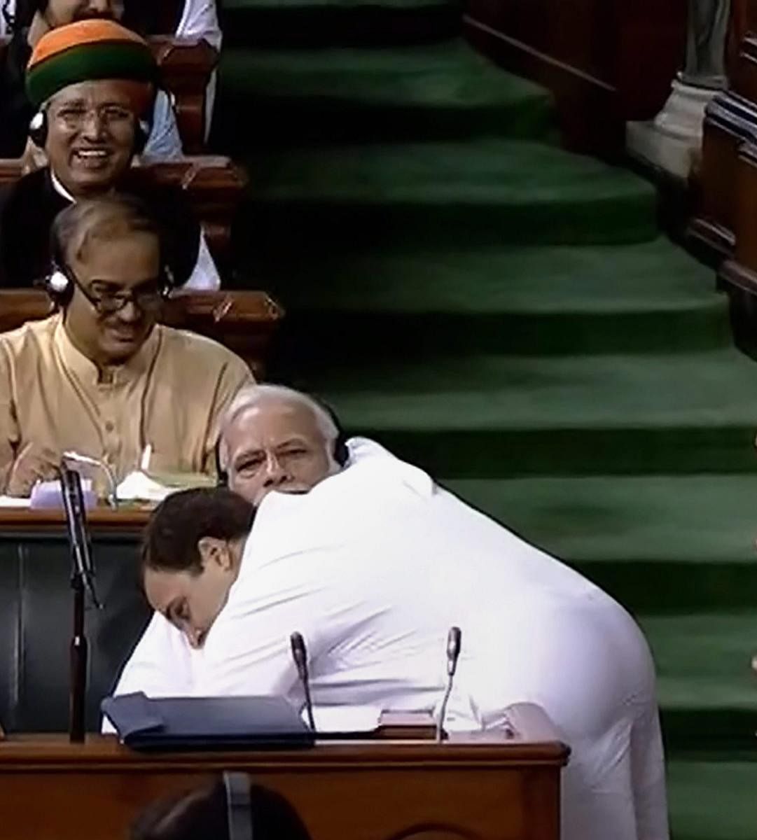 Congress President Rahul Gandhi hugs Prime Minister Narendra Modi after his speech in the Lok Sabha on 'no-confidence motion' during the Monsoon Session of Parliament, in New Delhi on July 20, 2018. PTI