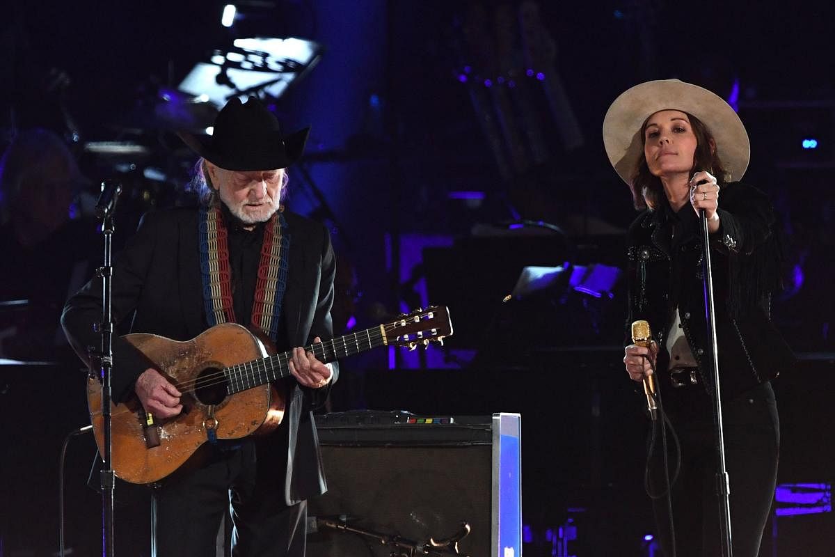 US musician Willie Nelson (L) and US singer-songwriter Brandi Carlile perform at the 2019 MusiCares Person Of The Year gala at the Los Angeles Convention Center in Los Angeles on February 8, 2019. - The 2019 MusiCares honor US singer-songwriter Dolly Part