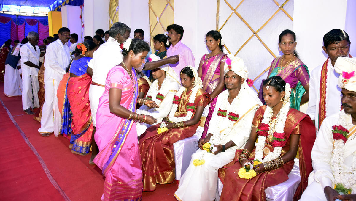 Family members wish the couples at the first Koraga mass marriage held at Kudmal Ranga Rao Community Hall at Kodikal in Mangaluru, on Sunday.