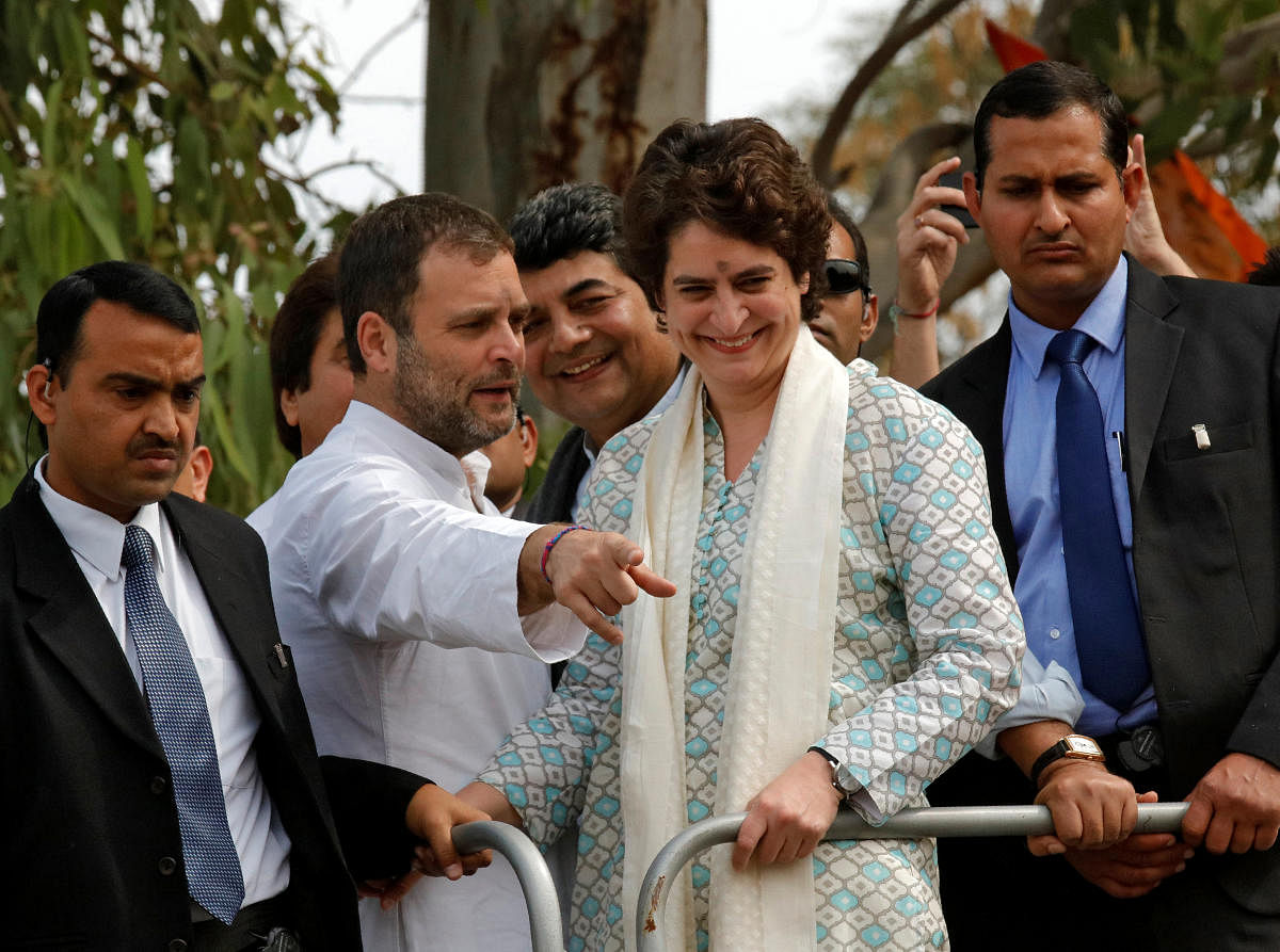 Rahul Gandhi, President of Congress party, flanked by his sister and a leader of the party Priyanka Gandhi Vadra, gestures during a roadshow in Lucknow. Reuters
