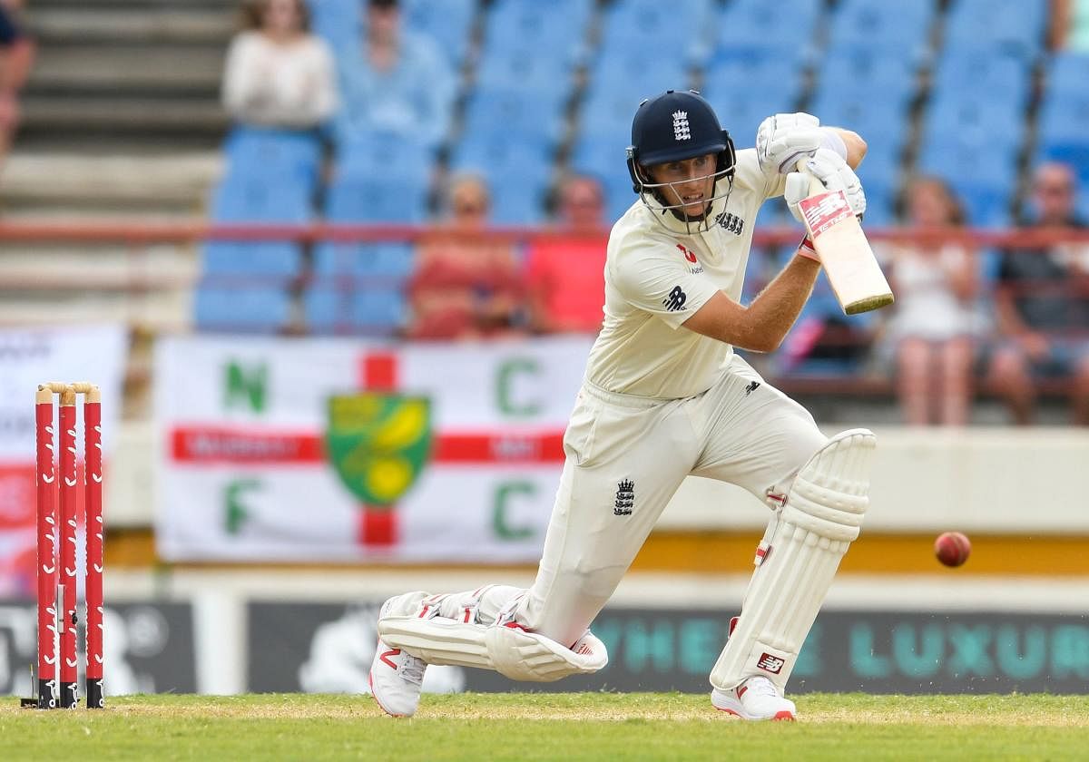 STEPPING UP: England skipper Joe Root drives one to the fence en route his unbeaten 111 on the third day of the third Test against the West Indies in St Lucia on Monday. AFP 