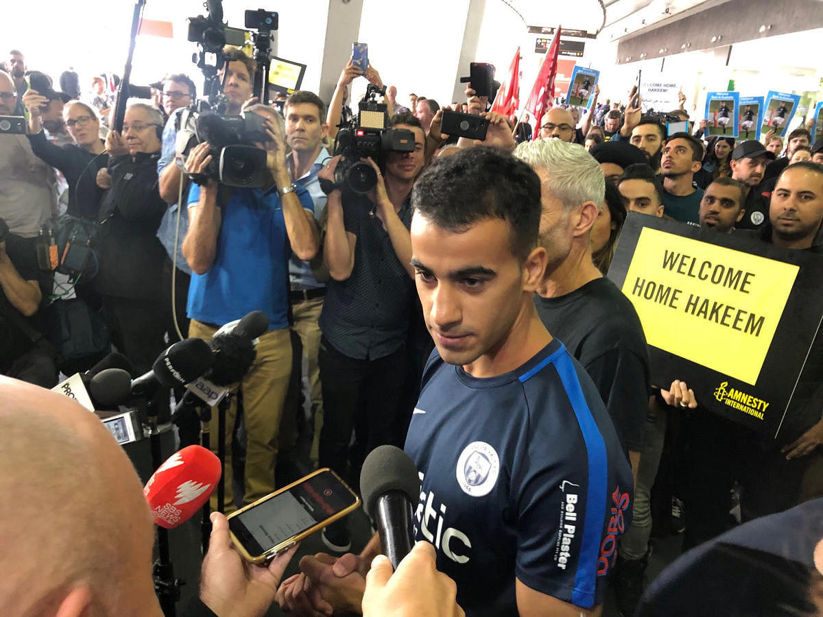 Hakeem al-Araibi, a refugee Bahraini footballer who was released from a Thai prison, talks to the media as he arrives at the airport in Melbourne, Australia February 12, 2019 in this picture obtained from social media. (Australian Council of Trade Unions/