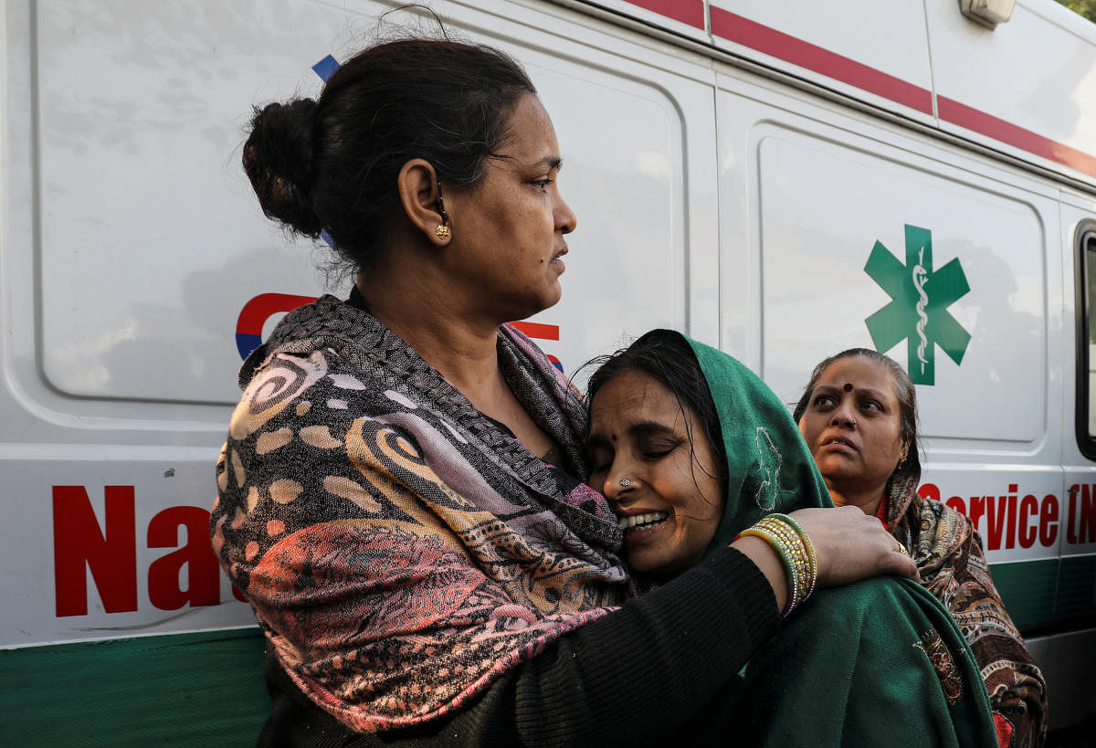 A woman cries as she cannot find her relative who was staying in a hotel where a fire broke out in New Delhi, India, February 12, 2019. REUTERS