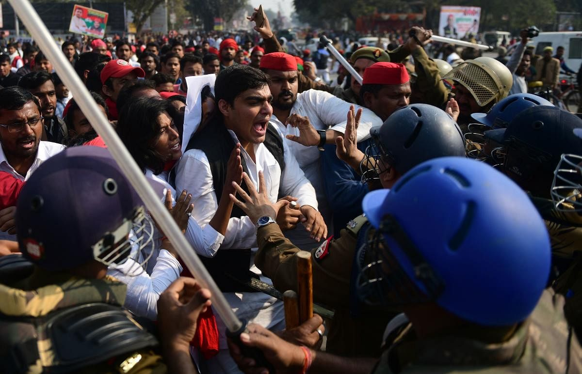 Indian policemen scuffle with Samajwadi Party activist during a protest after their party chief Akhilesh Yadav was stopped from boarding a plane at Lucknow airport, in Allahabad on February 12, 2019. (AFP Photo)