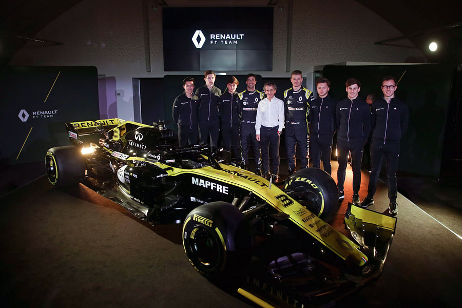 Former F1 champion Alain Prost (centre) is flanked by Renault F1 Team drivers Nico Hulkenberg (on his left) and Daniel Ricciardo and other team members during the 2019 car launch on Tuesday. AFP Photo