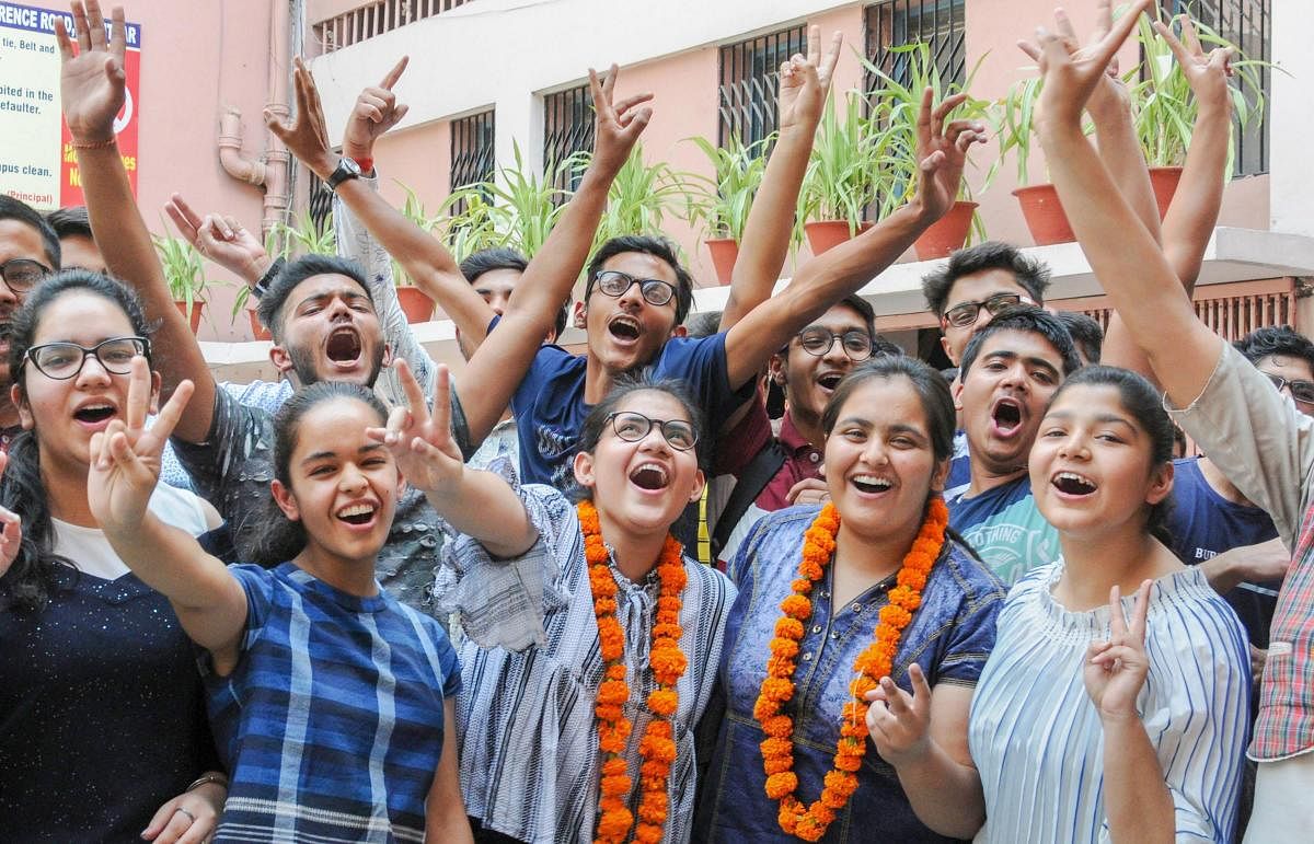Students celebrate after the results of CBSE Class 10th were announced, in Amritsar on Tuesday. PTI