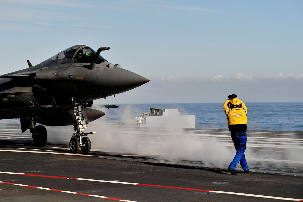 FILE PHOTO: A French fighter jet Rafale prepares to take off on the aircraft carrier "Charles de Gaulle", after the completion of its 18 month-long renovation in Toulon, France, November 8, 2018. Christophe Simon/File Photo