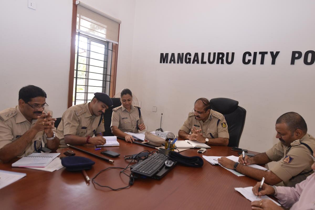 City Police Commissioner T R Suresh receives a call during a phone-in programme in Mangaluru.