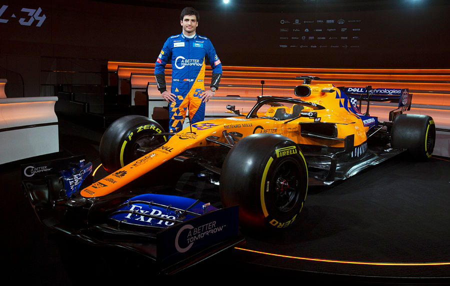 Carlos Sainz with the new McLaren MCL34 car. Picture credit: McLaren Racing