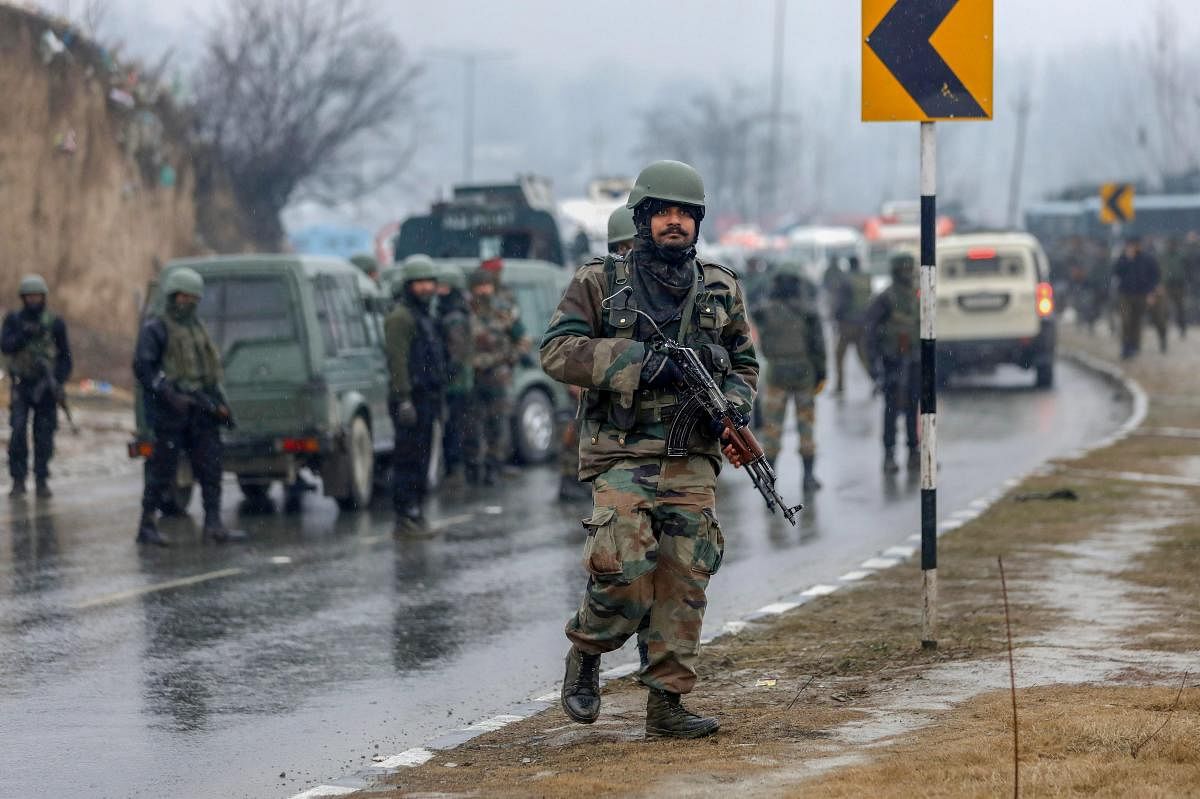 Army soldiers near the site of suicide bomb attack at Lathepora Awantipora in Pulwama district of south Kashmir, Thursday, February 14, 2019. At least 30 CRPF jawans were killed and dozens other injured when a CRPF convoy was attacked. (PTI Photo)