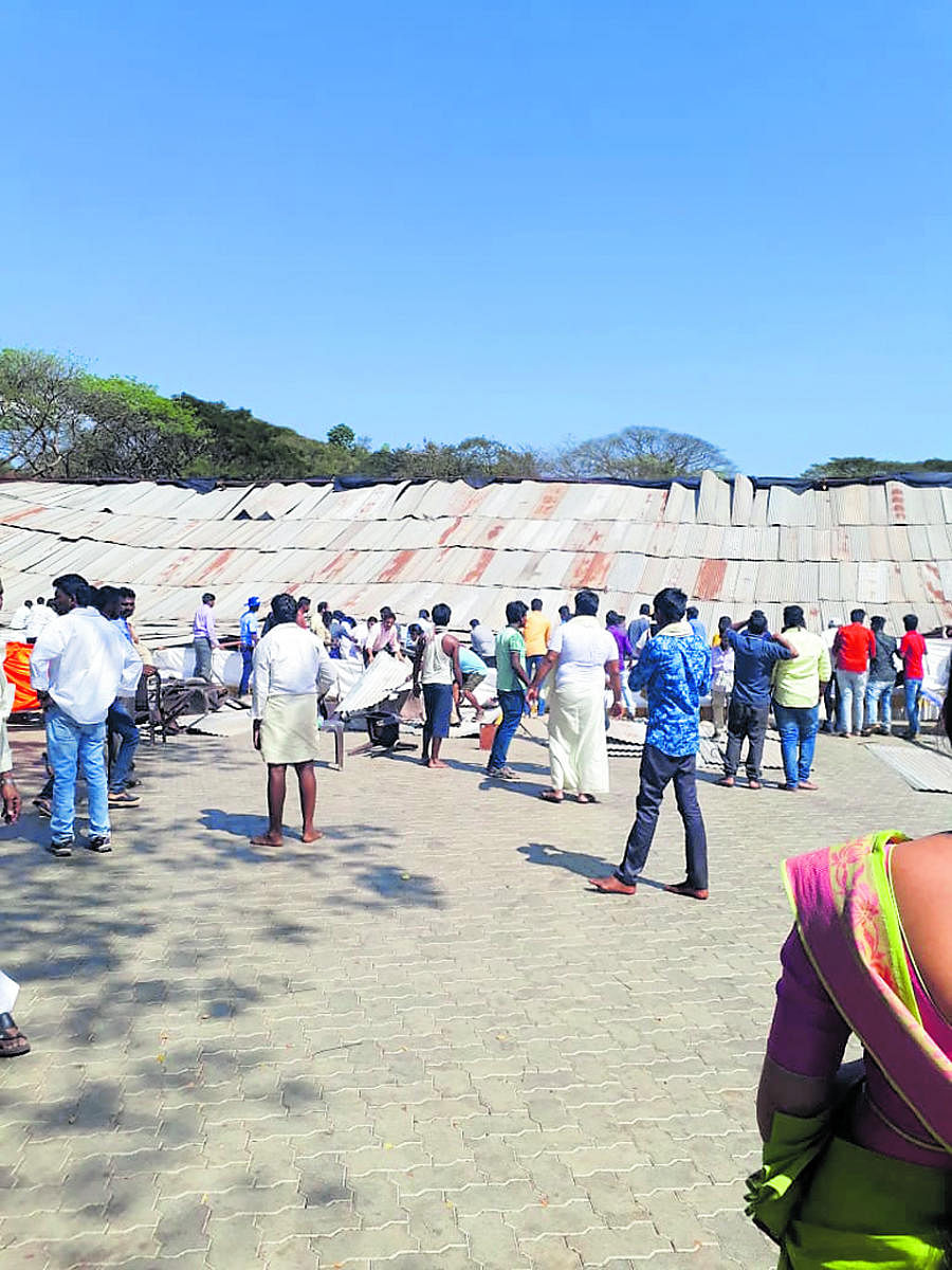A crowd gathers around the Panchamahavaibhava venue after the main dais collapsed during the Mahamastakabhishekha celebrations in Dharmsthala on Thursday. dh photo