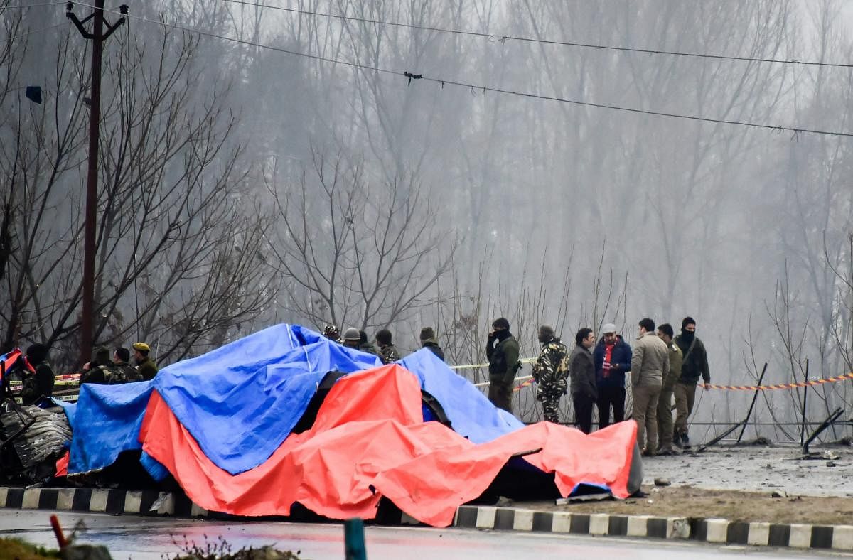 Security agencies inspect the site of suicide bomb attack at Lethpora area, in Pulwama district of south Kashmir. PTI