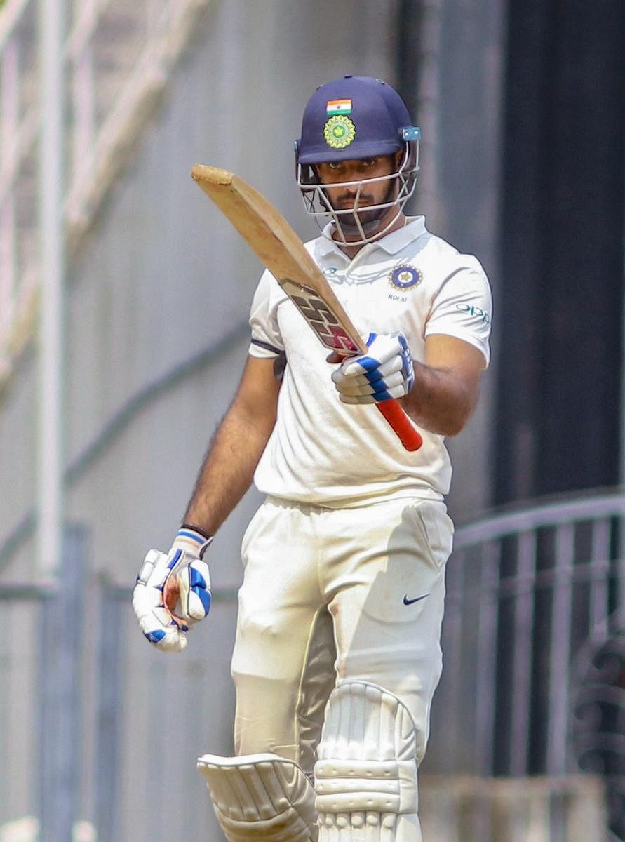 RUN MACHINE: Rest of India batsman Hanuma Vihari acknowledges his team-mates after reaching his century against Vidarbha during their Irani Cup match in Nagpur on Friday. PTI