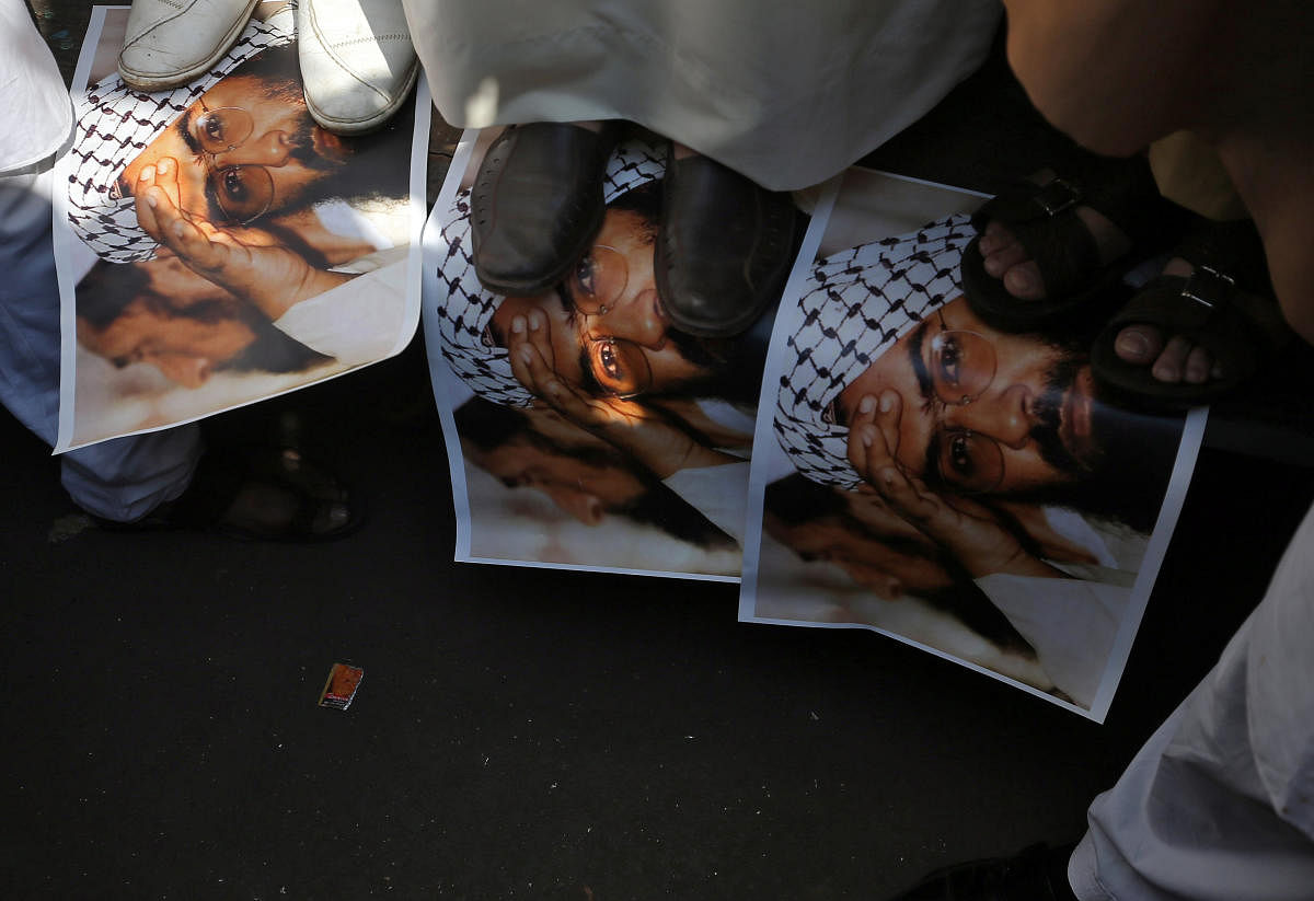 Demonstrators step on the posters of Maulana Masood Azhar, head of Pakistan-based militant group Jaish-e-Mohammad which claimed attack on a bus that killed 44 Central Reserve Police Force (CRPF) personnel in south Kashmir on Thursday, during a protest in Mumbai, India on Friday. (REUTERS)