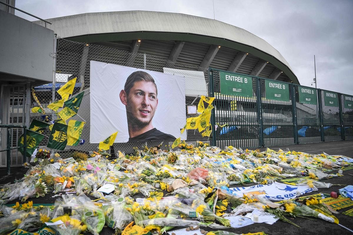 Flowers are displayed in front of the portrait of Argentinian forward Emiliano Sala at the Beaujoire stadium in Nantes, France. (AFP File Photo)