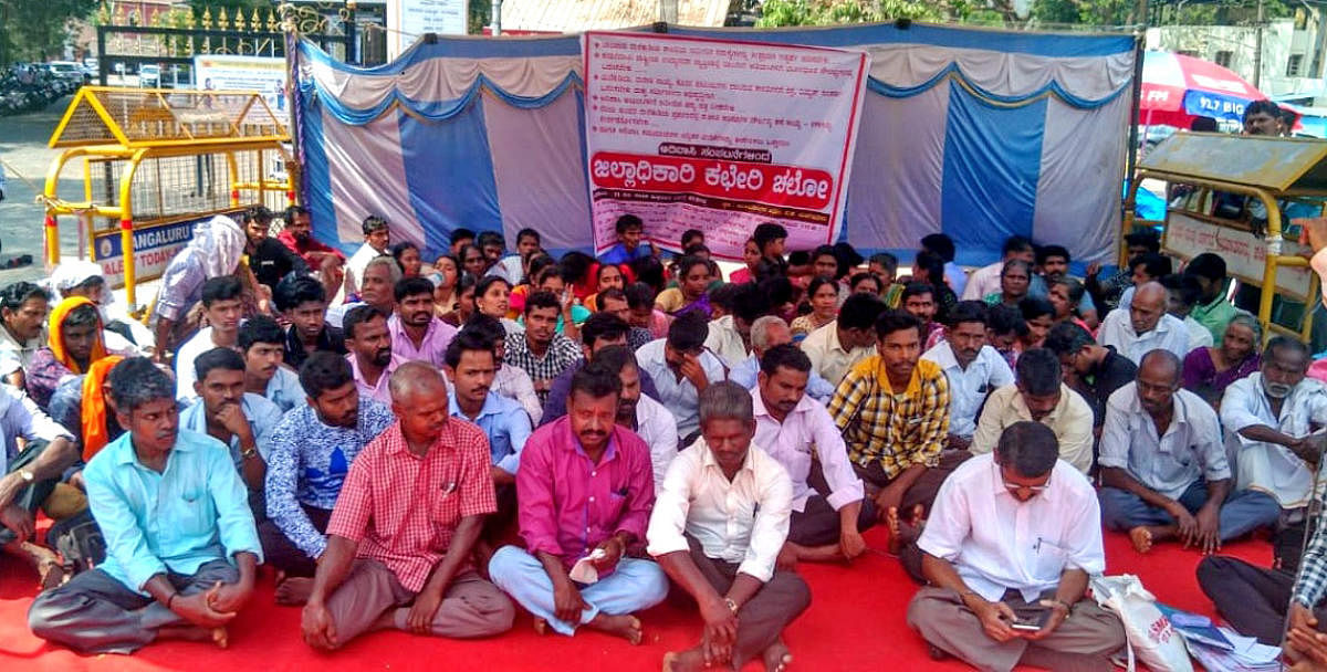 Members of Karnataka Adivasi Hakkugala Samanvaya Samithi, Belthangady taluk, in association with other organisations, stage a protest in front of deputy commissioner’s office in Mangaluru on Friday.