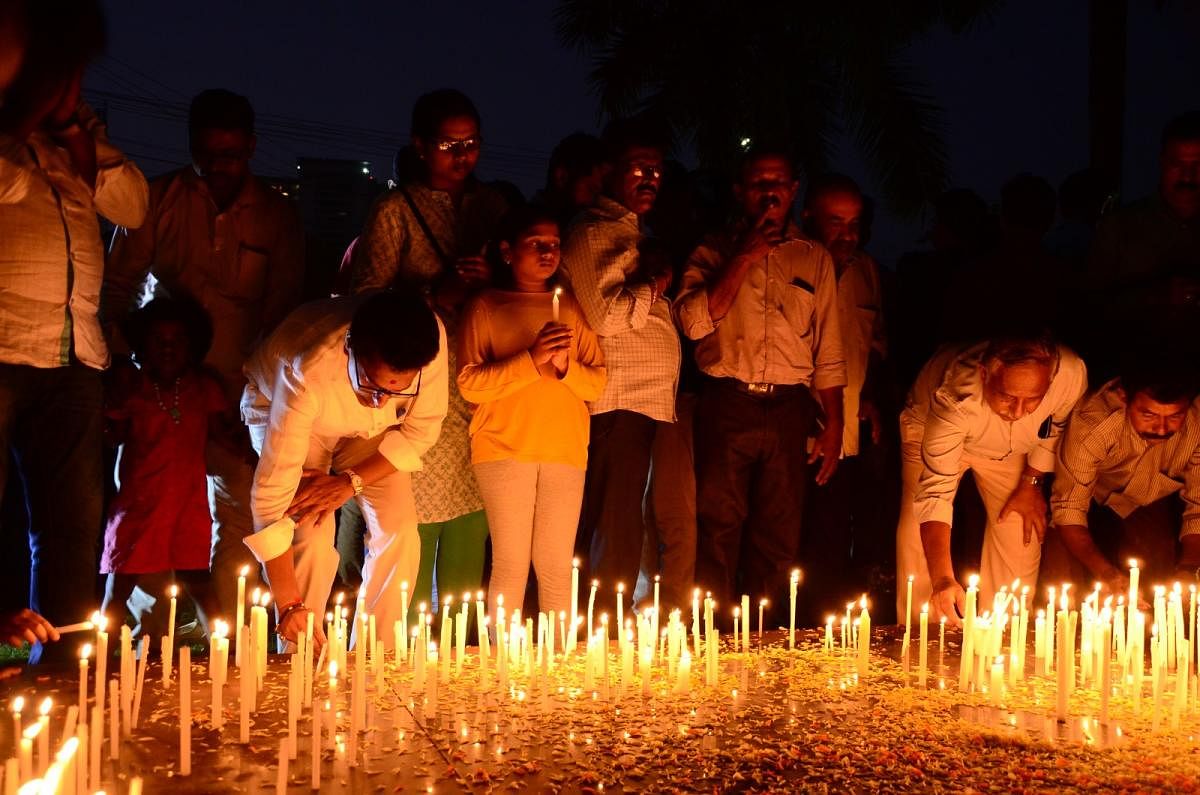 Public light candles, as a tribute to the paramilitary CRPF personnel who were killed in fidayeen attack at Pulwama, at War Memorial in Kadri on Friday.