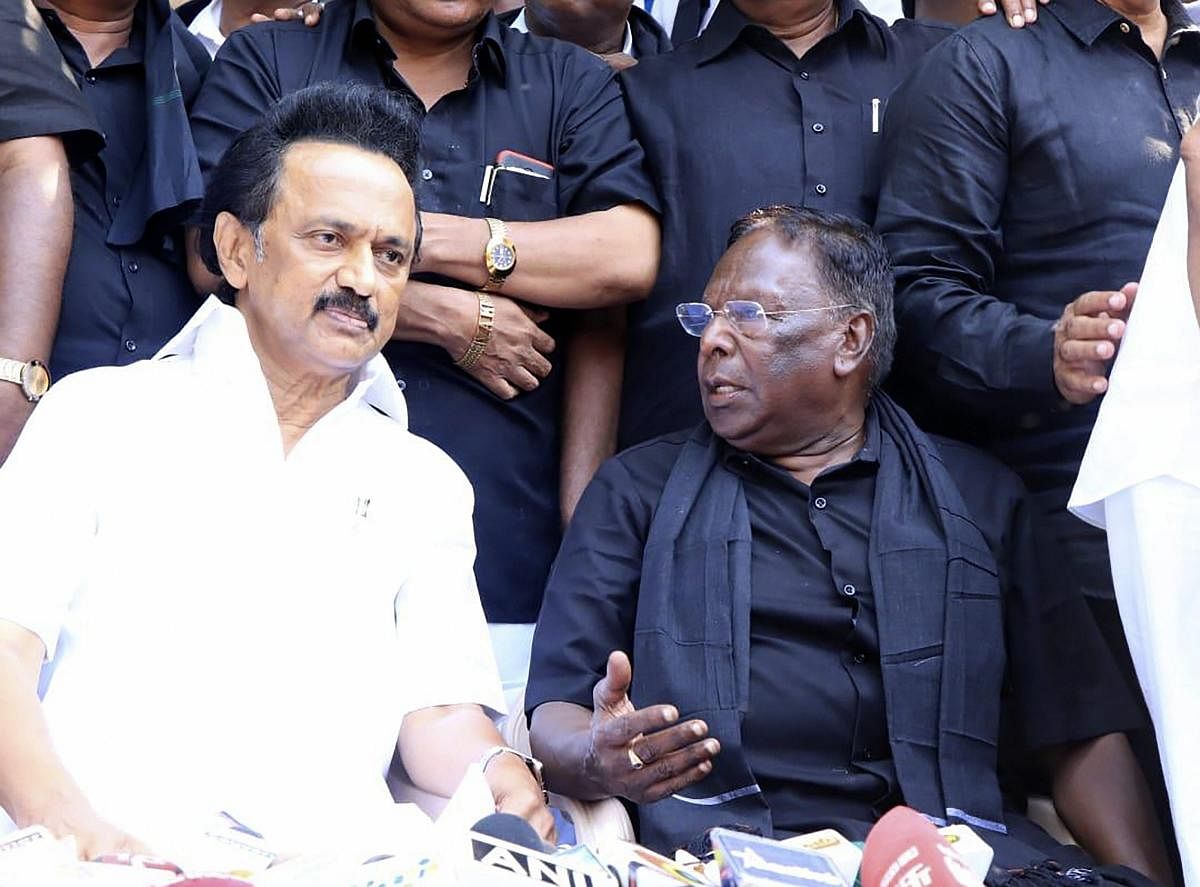 DMK President MK Stalin speaks with Puducherry Chief Minister V Narayanasamy during a dharna outside the office of Puducherry Lt Governor Kiran Bedi on the fifth day of protest, in Puducherry, Sunday, Feb 17, 2019. (PTI Photo)