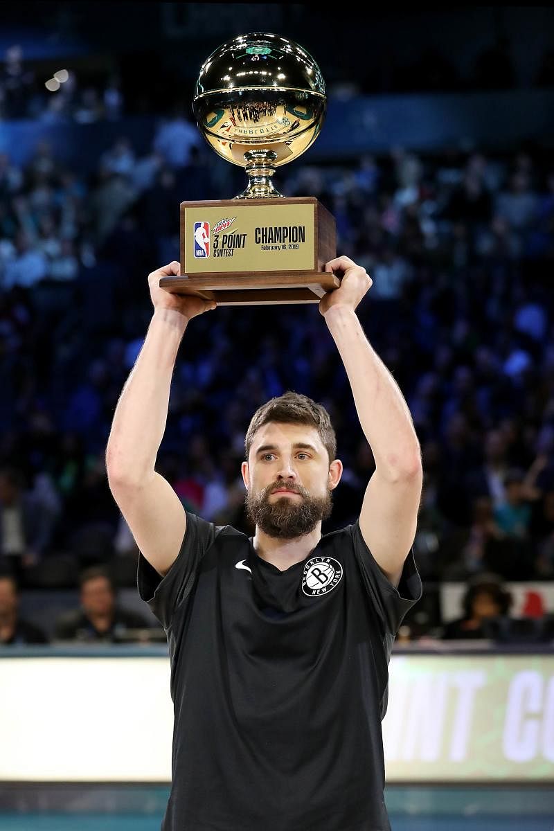 CHARLOTTE, NORTH CAROLINA - FEBRUARY 16: Joe Harris #12 of the Brooklyn Nets celebrates with the trophy after winning the MTN DEW 3-Point Contest as part of the 2019 NBA All-Star Weekend at Spectrum Center on February 16, 2019 in Charlotte, North Carolina