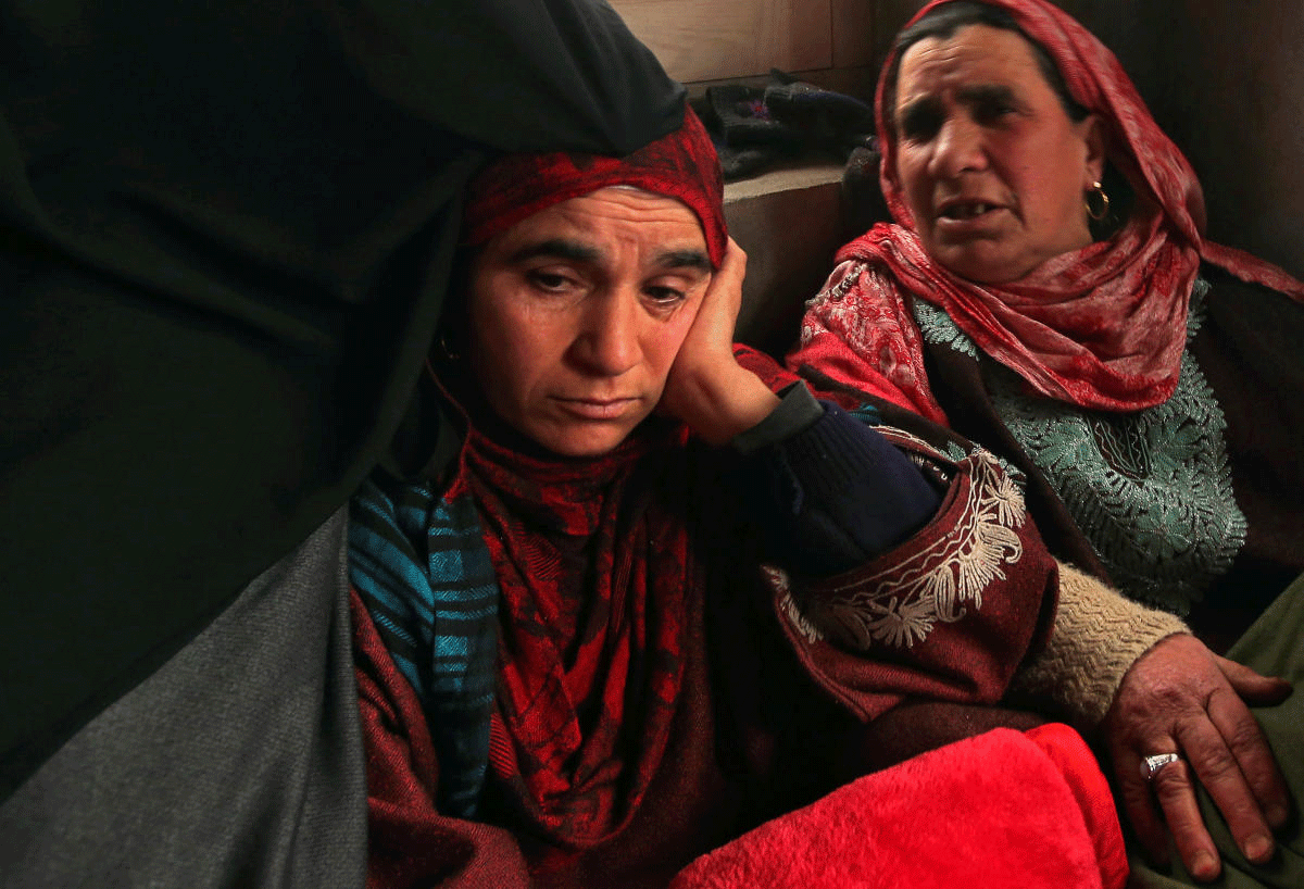 Fahmeeda, mother of Adil Ahmad Dar, who according to police carried out the suicide attack on CRPF convoy and killed 44 on Thursday, sits inside her home in Gundbagh. Reuters photo
