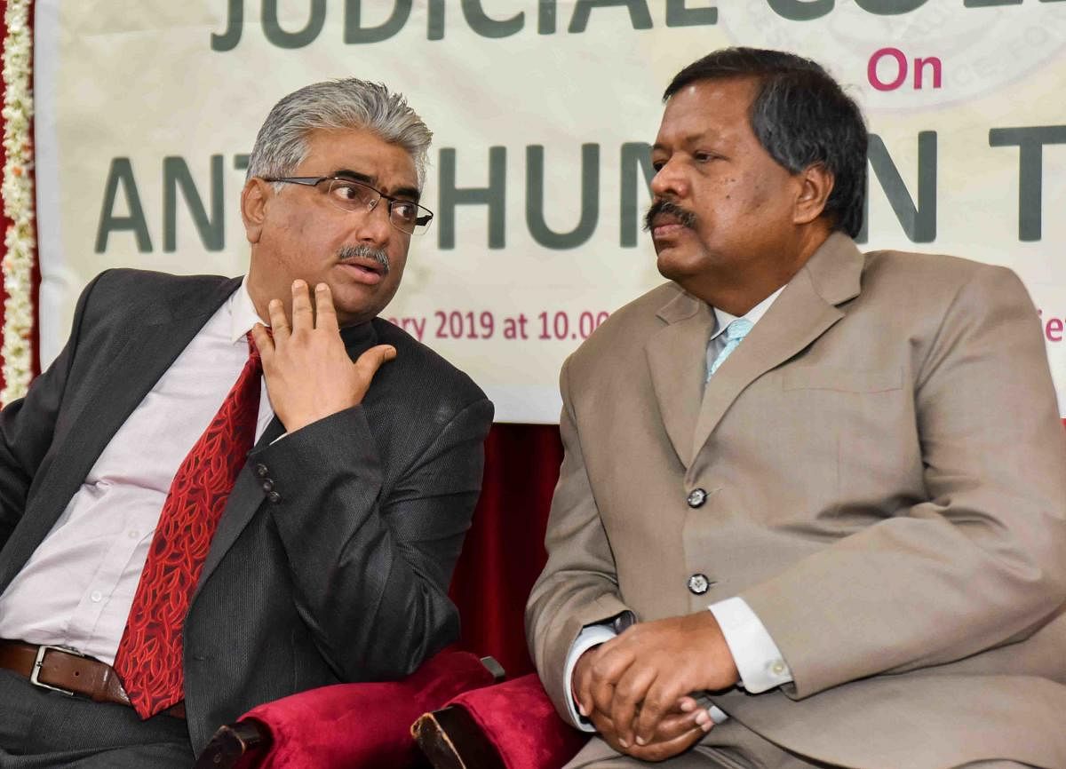 High Court Chief Justice L Narayana Swamy speaks with High Court Judge Arvind Kumar on the seminar with judicial officials on the Karnataka Law Services Authority and the High Court Legal Services Committee on Sunday.