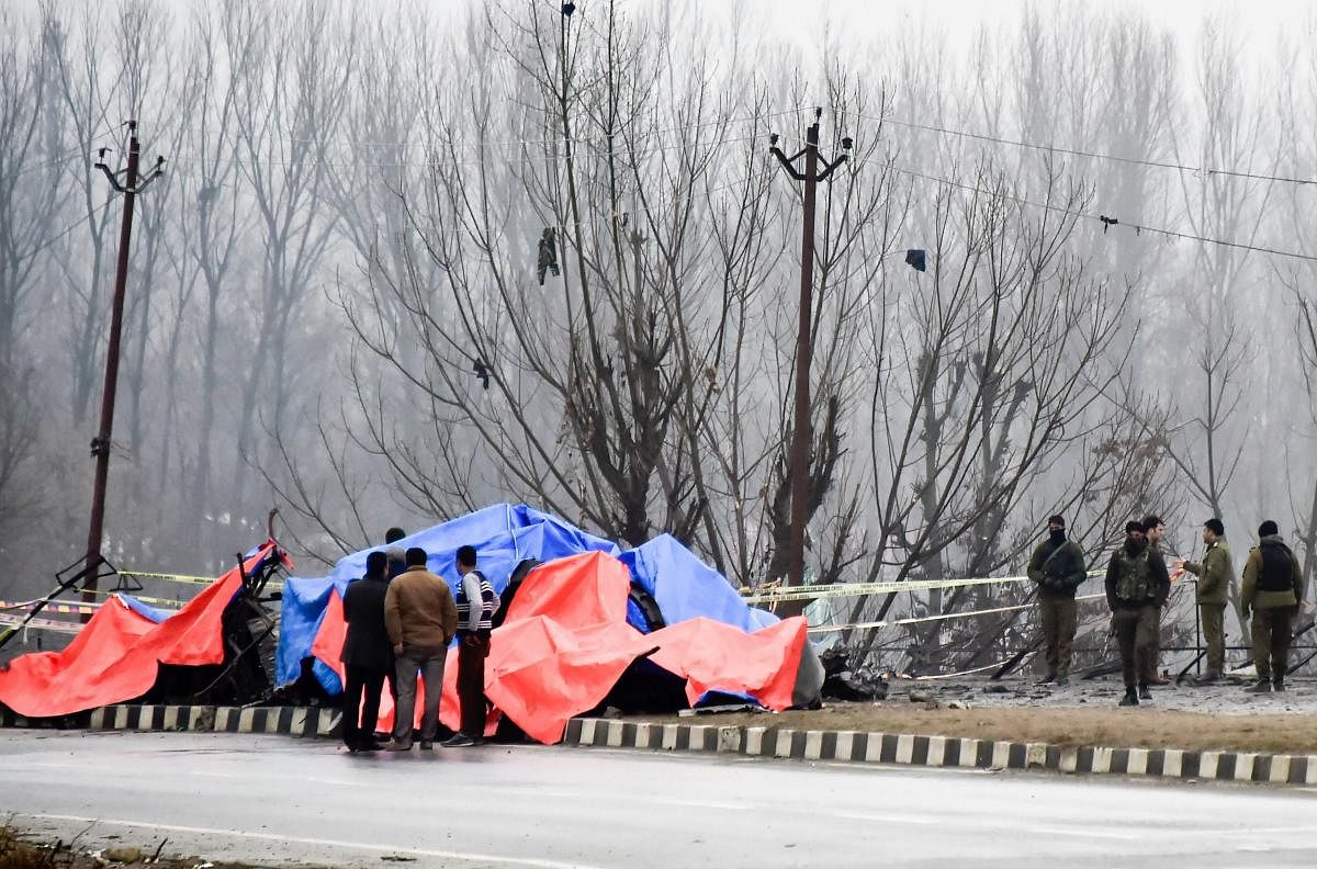 Security agencies inspect the site of a suicide bomb attack at Lethpora area, in Pulwama district of south Kashmir. (PTI Photo)