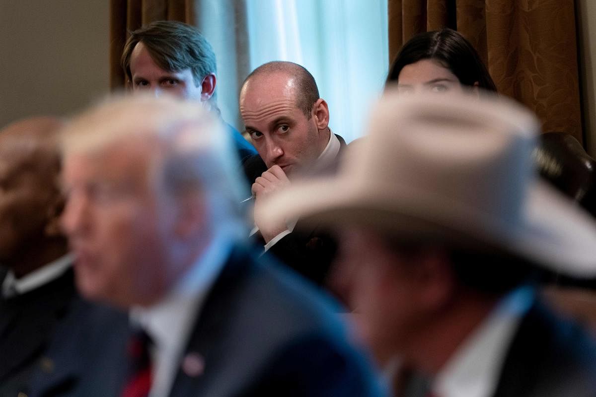 In this file photo, advisor Stephen Miller listens while US President Donald Trump speaks during a meeting on border security in the Cabinet Room of the White House in Washington, DC. AFP