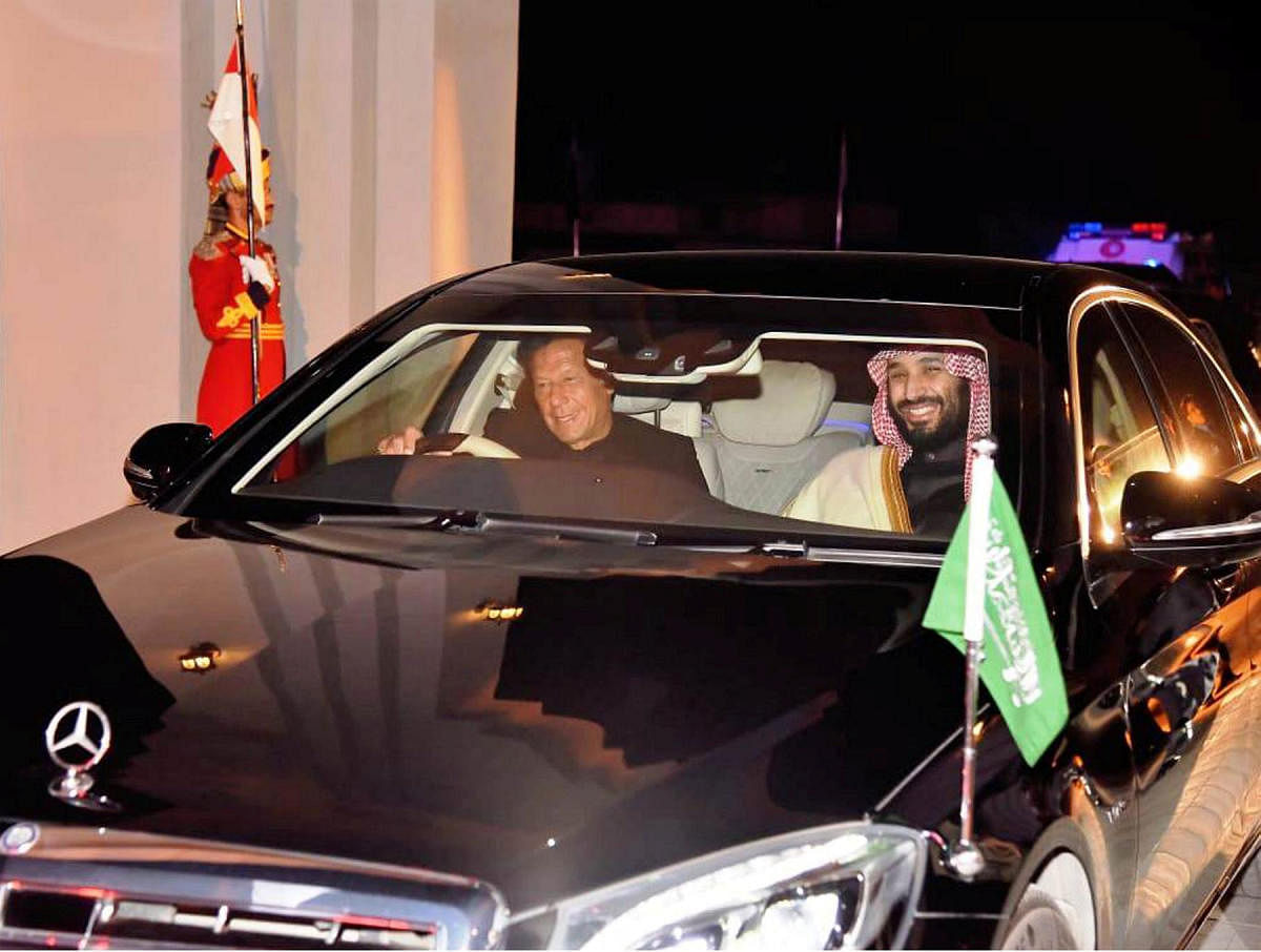 Pakistani Prime Minister Imran Khan (L) drives a vehicle as he receives Saudi Arabia's Crown Prince Mohammed bin Salman on his arrival at Pakistan Air Force (PAF) Nur Khan Base in Rawalpindi, Pakistan February 17, 2019. (Press Information Department (PID)/Handout via REUTERS)