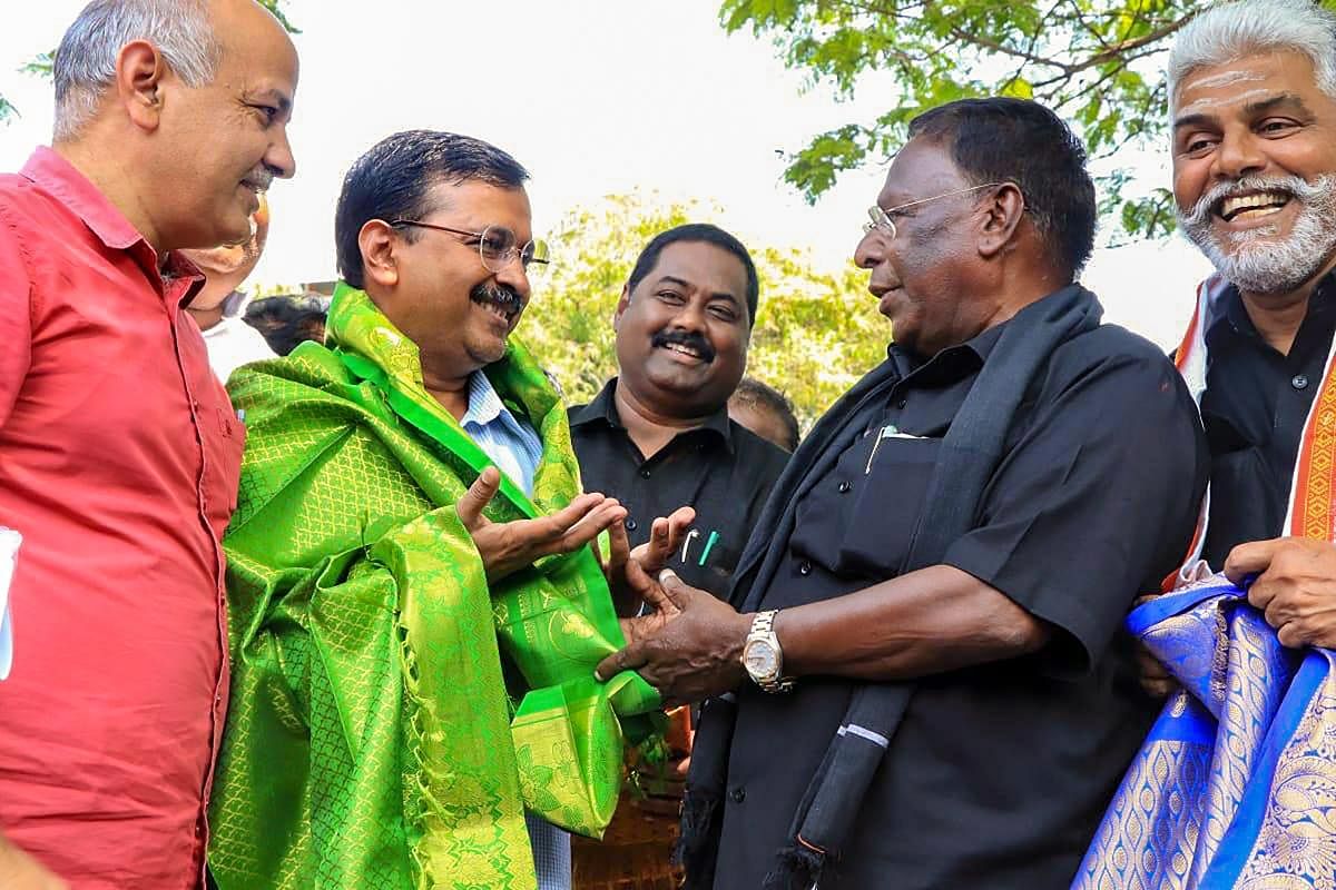Puducherry Chief Minister V Narayanasamy welcomes Delhi Chief Minister Arvind Kejriwal as he arrives to support his 'dharna' outside the official residence of Lt Governor Kiran Bedi for not permitting implementation of his government's welfare schemes, in Puducherry, Monday, Feb. 18, 2019. (PTI Photo)