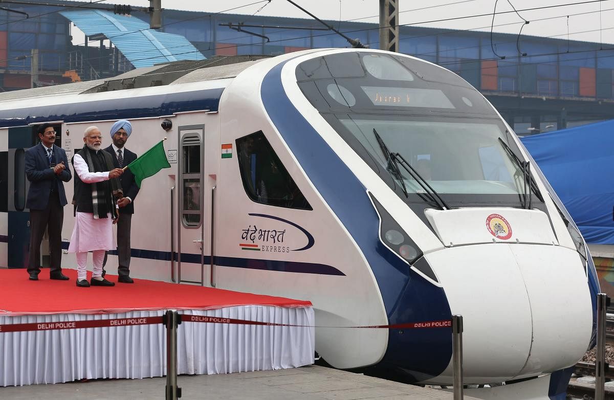 In this photo taken on February 15, 2019, Indian Prime Minister Narendra Modi (2nd L) flags off India's first semi-high speed express train Vande Bharat Express at New Delhi Railway Station. - India's first semi-high speed express train February 16 broke
