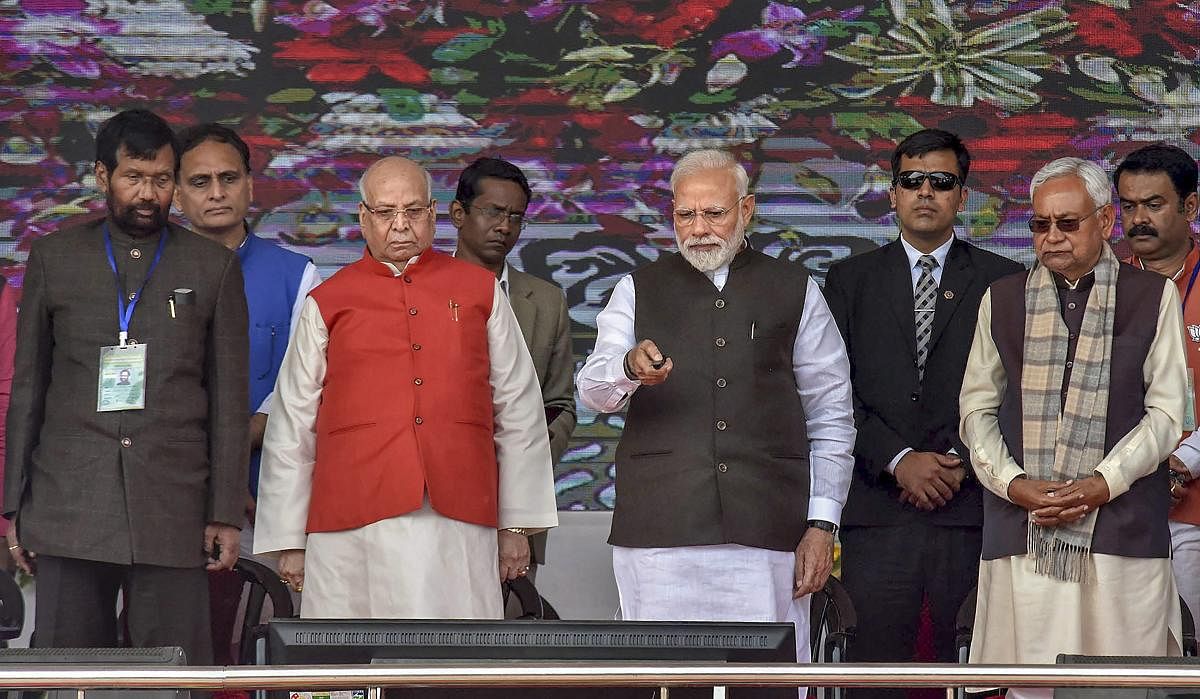 Prime Minister Narendra Modi flanked by Bihar Governor Lalji Tandon and Chief Minister Nitish Kumar during the inauguration and foundation stone-laying ceremony of various development projects, in Begusarai. Also seen is Union Minister Ram Vilas Paswan. (