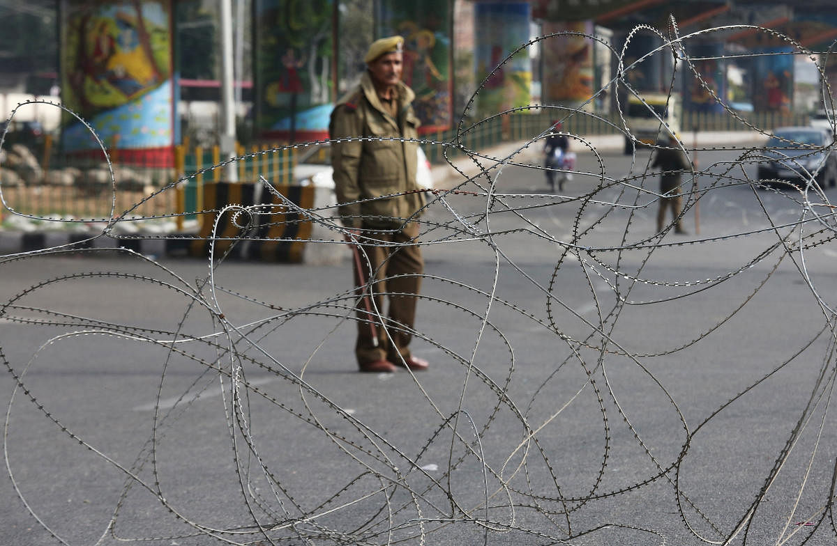 A policeman stands guard at a street in Jammu. Reuters file photo