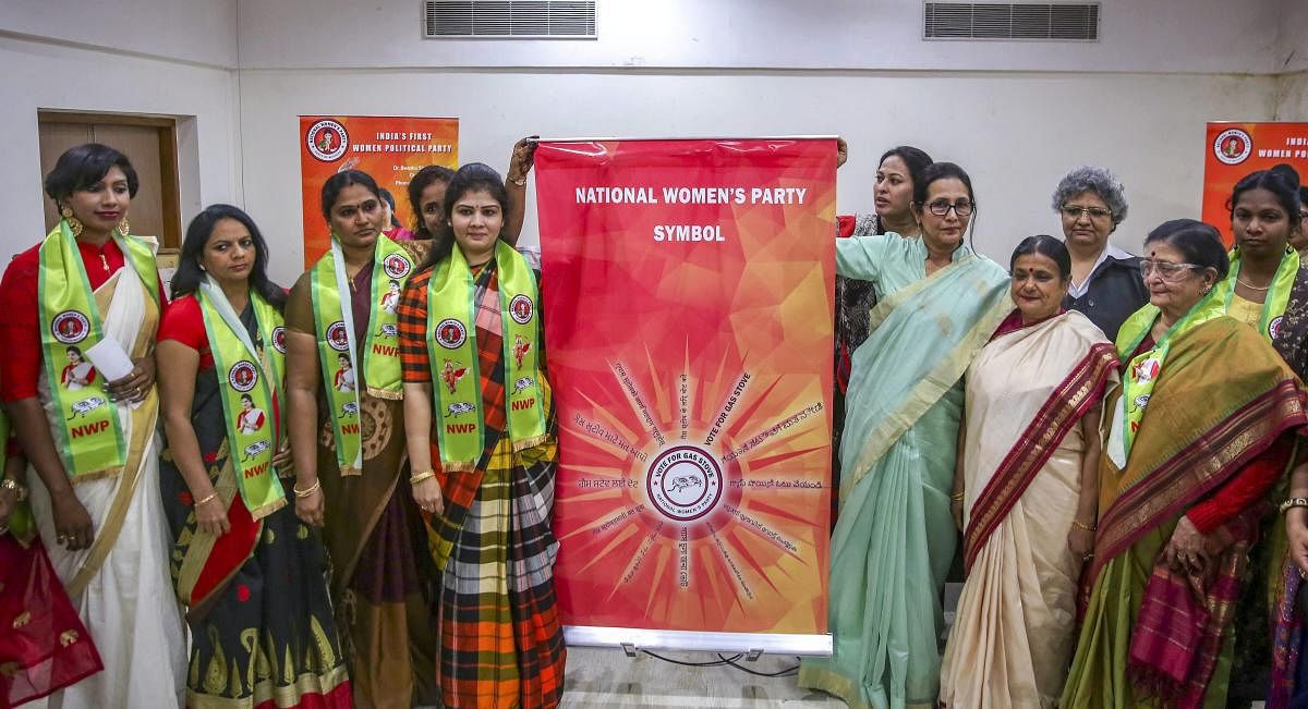 National Women's Party founder Shweta Shetty (4th from L) along with the party members unveils the party's symbol and flag for the upcoming Lok Sabha elections, in New Delhi on Thursday. PTI