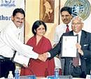 Forging bonds: BDA Commissioner Bharat Lal Meena and Corporation Bank CMD Ramnath Pradeep shake hands after signing the MoU in the City on Tuesday. BDA Chairman  Vatsala Vastsa is also seen. DH Photo