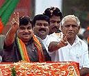 Bharatiya Janata Party (BJP) President Nitin Gadkari with Karnataka CM B S Yeddyurappa waves to party workers during the celebration of the completion of Chief minister B S Yeddyurappa's 1,000 days in office, at the Bangalore Palace Grounds on Sunday. PTI