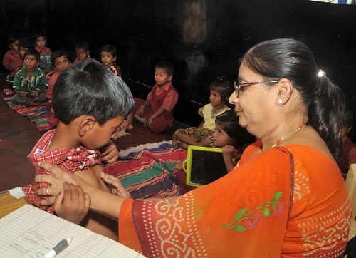 A doctor check-up the medical condition of a school kid. DH photo